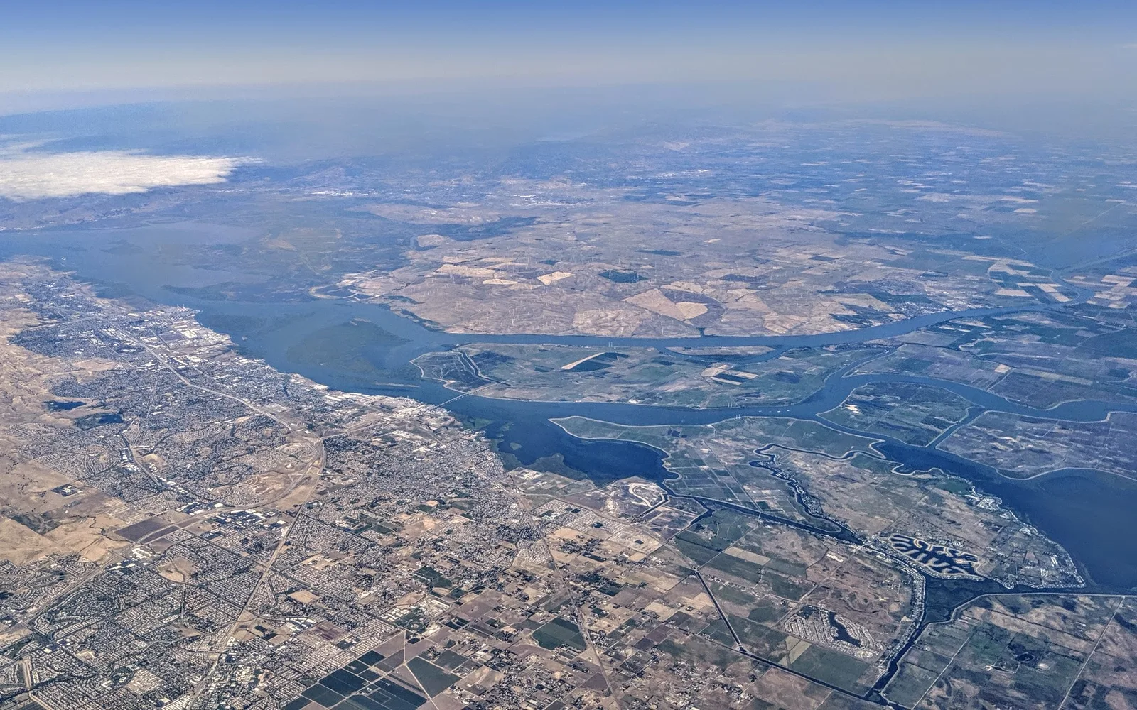 Aerial view of the confluence of the San Joaquin and Sacramento Rivers at Antioch with the waterfront visible on the shore